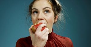 A-young-woman-eating-an-apple